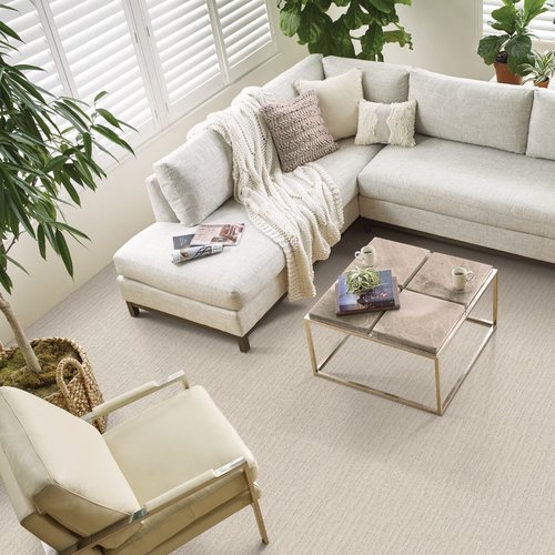 white armchair and white couch in living room with white carpet from Green Carpet Co. - The Flooring Connection in San Antonio, TX